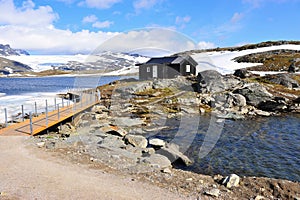 Black wooden house with snowy landscape