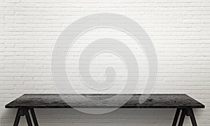 Black wooden table with legs. White brick wall texture in background