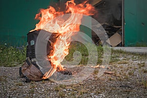 Worn motorcycle boots burning photo