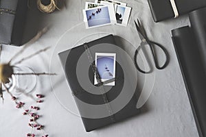 Black wrapped Christmas gift box, ornated with and instant photo film