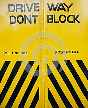 Black and yellow gate with sign