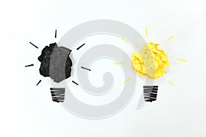 Black and yellow light bulb crumpled paper isolated in white background. Bright ideas and new innovation concept.