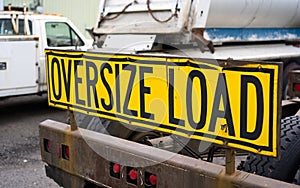 Oversize load sign on the back of big rig semi truck tractor on photo