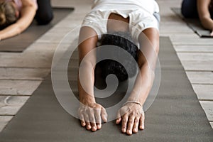 Black yogi woman and group of people doing Child exercise