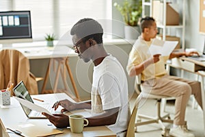 Black Young Man Working in Office Side View