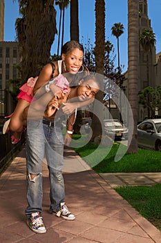 Black young urban couple making fun in street