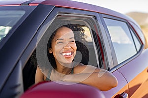 Black young woman looking outside car