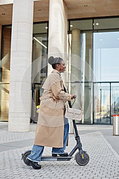 Black Young Woman Riding Scooter in City