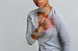 Black young woman suffering from acid reflux or heartburn