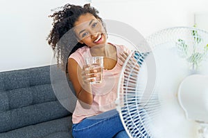 Black young woman suffering a heat wave at home