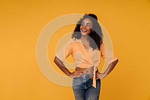 Black young woman wearing jeans smiling while looking aside