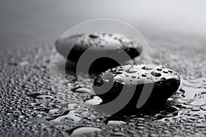 Black zen stones with water drops