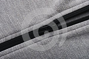 Black zipper on grey textile