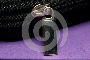 black zipper lock close-up on a colored background