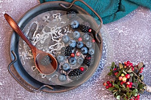 Blackberries and blueberries on a metal platter.