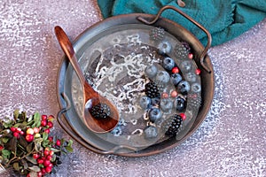 Blackberries and blueberries on a metal platter.