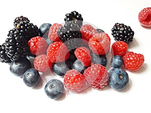 Blackberries, raspberries and blueberries on white background