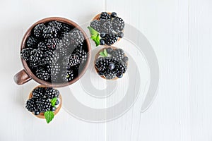 Blackberries and tartlets with blackberries top view on a wooden background with a place for an inscription. Blackberries and
