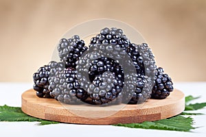 Blackberries on wooden plate