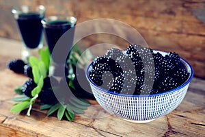 Blackberry fruit liqueur in two shot glasses with berries and gr