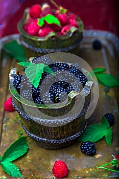 Blackberry with leaf in a basket on vintage metal tray. Top view. Close up.