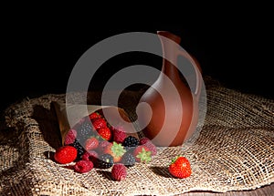 Blackberry with raspberries and strawberry on a burlap background
