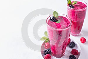 Blackberry and raspberry smoothies in glass with mint leaf and r