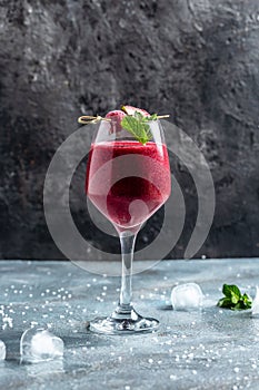 Blackberry and raspberry smoothies in glass with mint leaf and raw beeries on dark background. vertical image. top view. place for photo