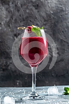 Blackberry and raspberry smoothies in glass with mint leaf and raw beeries on dark background. vertical image. top view. place for photo