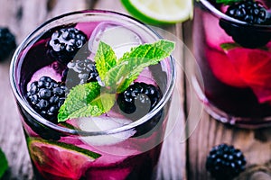 Blackberry smash cold cocktail with lime, and mint