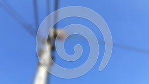 A blackbird, a wild animal, builds nests on the wires, of high voltage poles in rural roads in Thailand