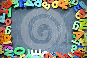 Blackboard background with colored letter blocks as frame