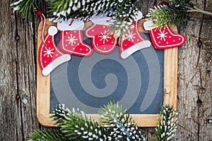 Blackboard blank framed in beautiful Christmas tree branches and