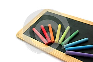 Blackboard and chalks in rainbow