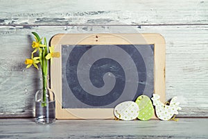 Blackboard with daffodils and Easter decoration