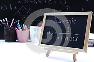 Blackboard with hand written Sequences and Series Formulas