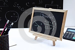 Blackboard with hand written Sequences and Series Formulas