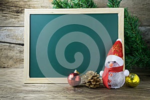 Blackboard With Red Santa Hat And Christmas snowman toy on old w