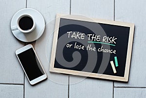 Blackboard saying TAKE THE RISK