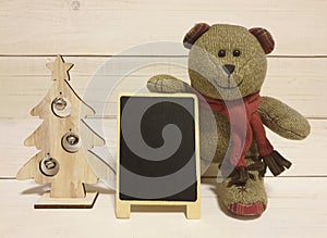 Blackboard for short note and christmas tree with teddy bear