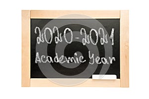 Blackboard with the text 2020 2021 academic year. School Board in wooden frame isolated on white background
