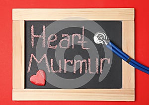 Blackboard with text HEART MURMUR and stethoscope