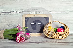 Blackboard with tulips and basket of eggs