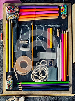 Blackboard with various art and craft tools