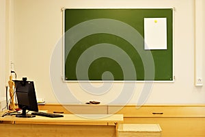 A blackboard on the wall in the classroom for teaching.