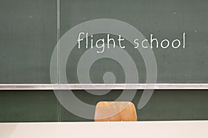 Blackboard word  Flight school  on a blackboard