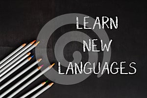 A blackboard with the words learn new languages written on it