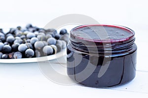 blackcurrant jam in a jar, jam on a white background