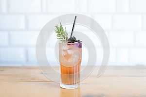 blackcurrant soda in a clear glass with a bendable straw