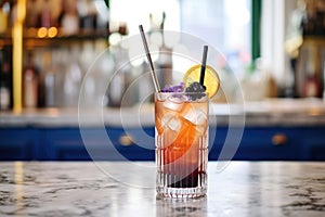 blackcurrant soda in a clear glass with a bendable straw